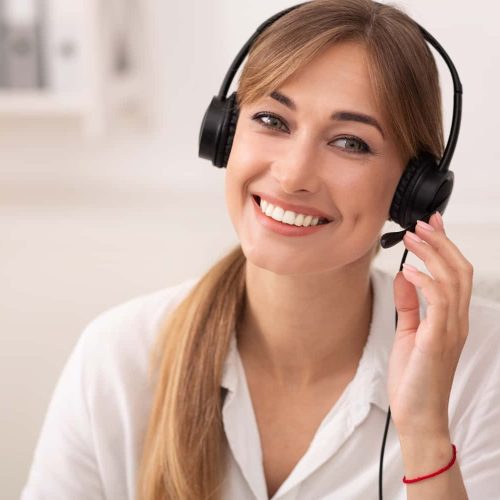 smiling-woman-in-headset-working-in-call-center-of-2022-12-16-08-38-43-utc-min